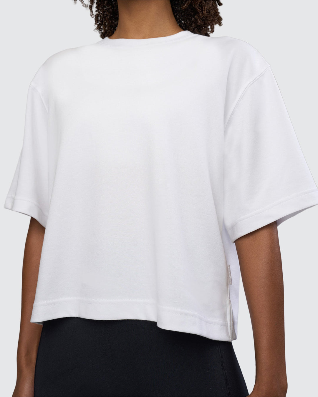 Woman wearing AfterDark ZeroCrease Cropped Tee - White | Model:Tomi | Size:S