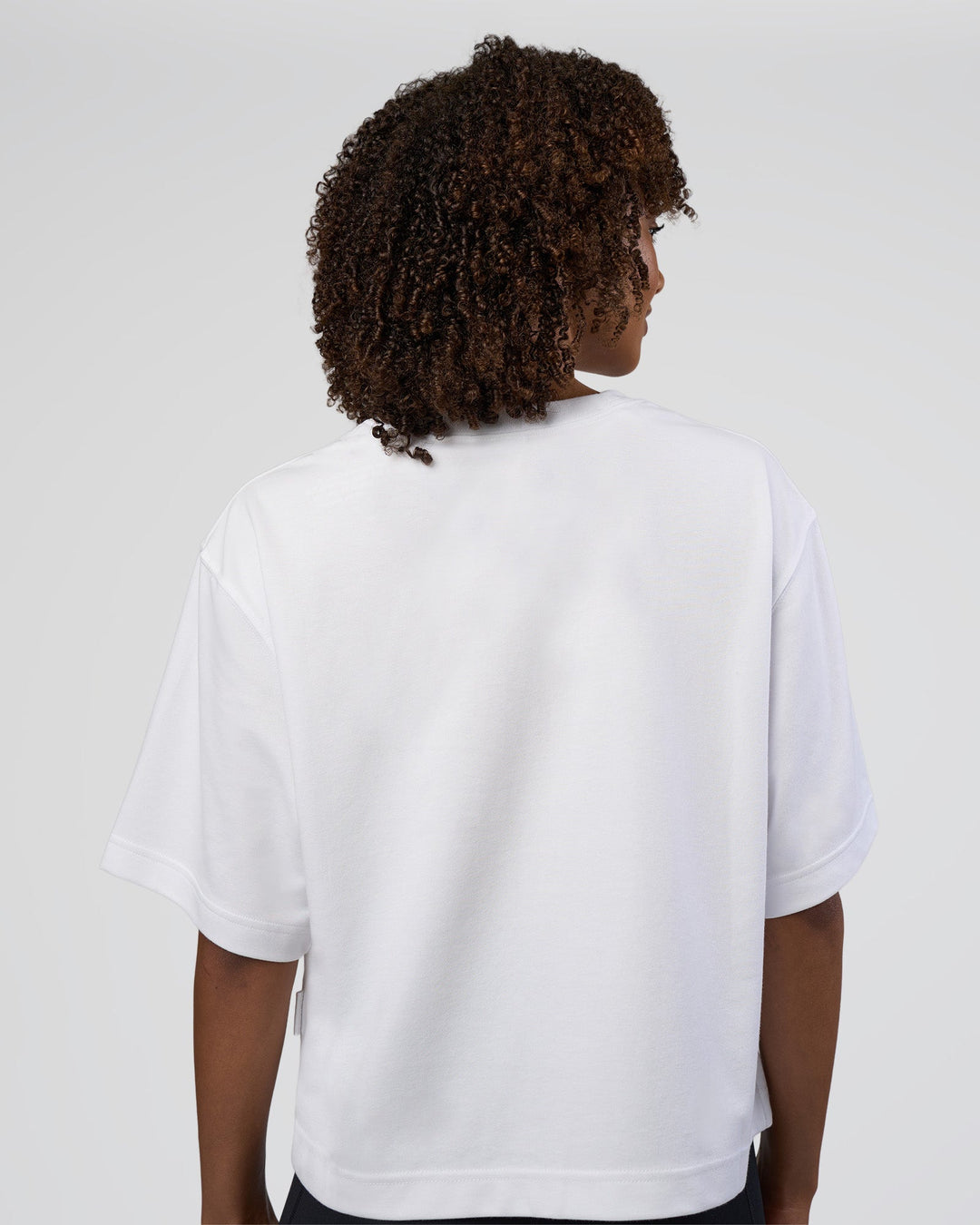 Woman wearing AfterDark ZeroCrease Cropped Tee - White | Model:Tomi | Size:S - view 2