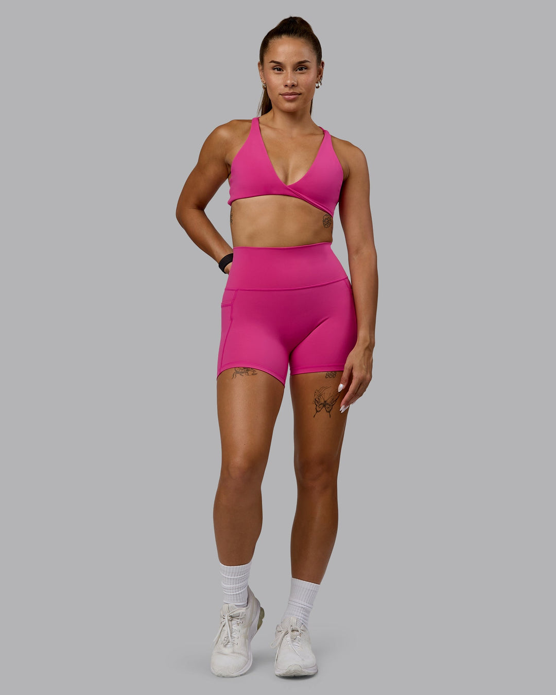 Woman wearing Agile Sports Bra - Fuchsia Pink