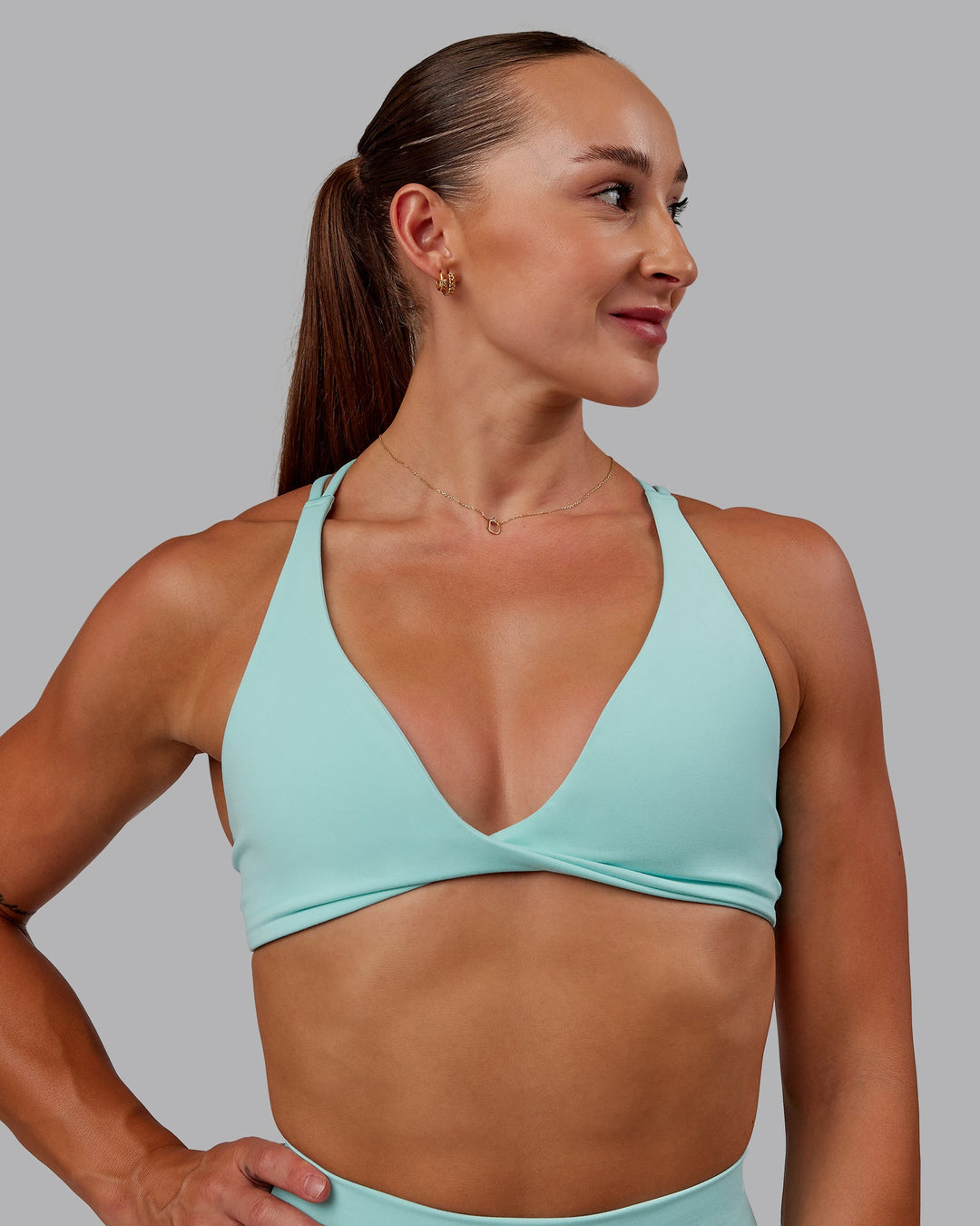 Woman wearing Agile Sports Bra in Island Paradise | Size:S