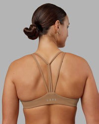 Woman wearing Agile Sports Bra - Warm Smoke | Model:Keisha | Size:S
