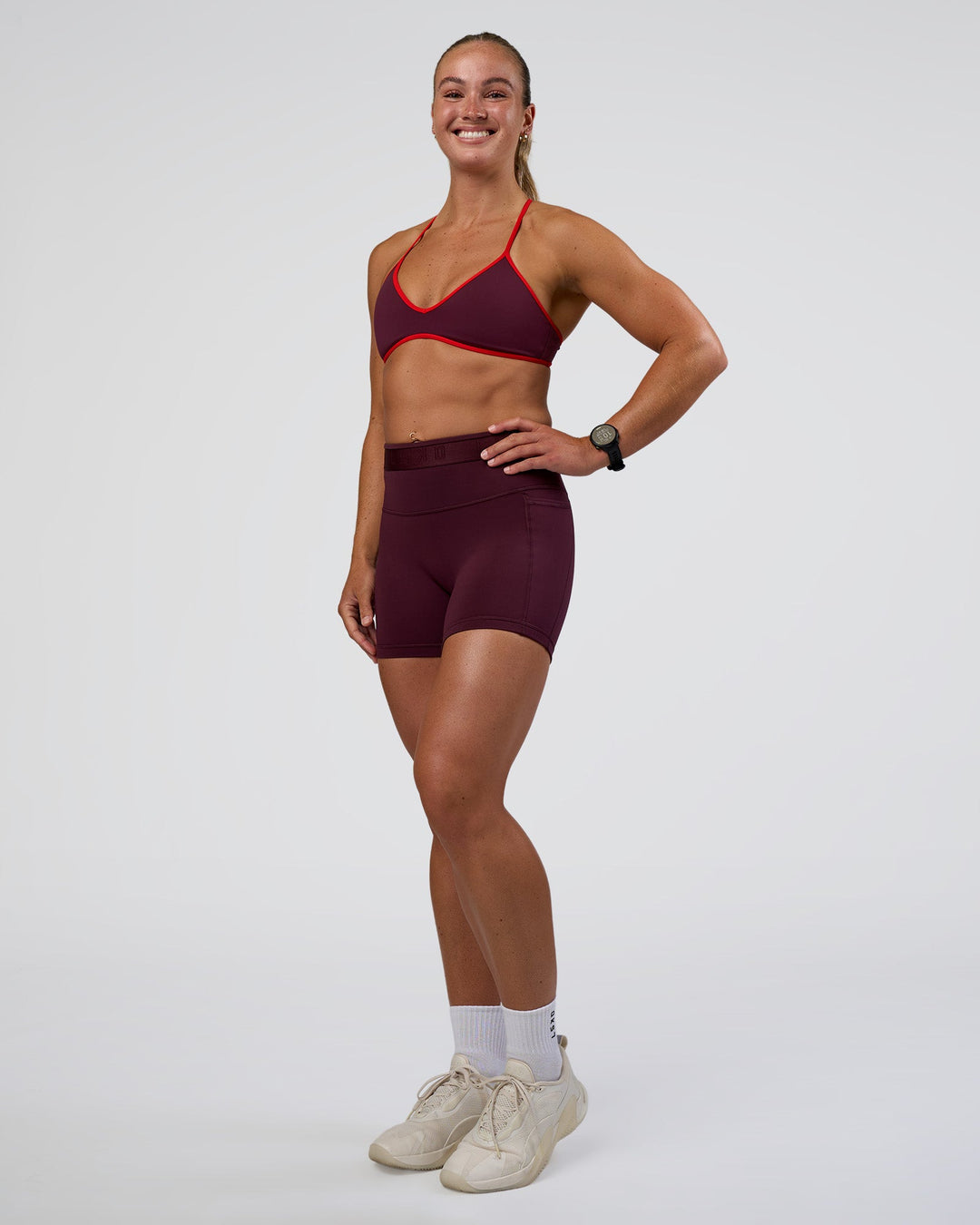 Woman wearing Ambience Sports Bra - Cherry Lacquer-Flame | Model:Sav | Size:S