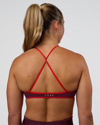 Woman wearing Ambience Sports Bra - Cherry Lacquer-Flame | Model:Sav | Size:S | Thumbnail Index: 0