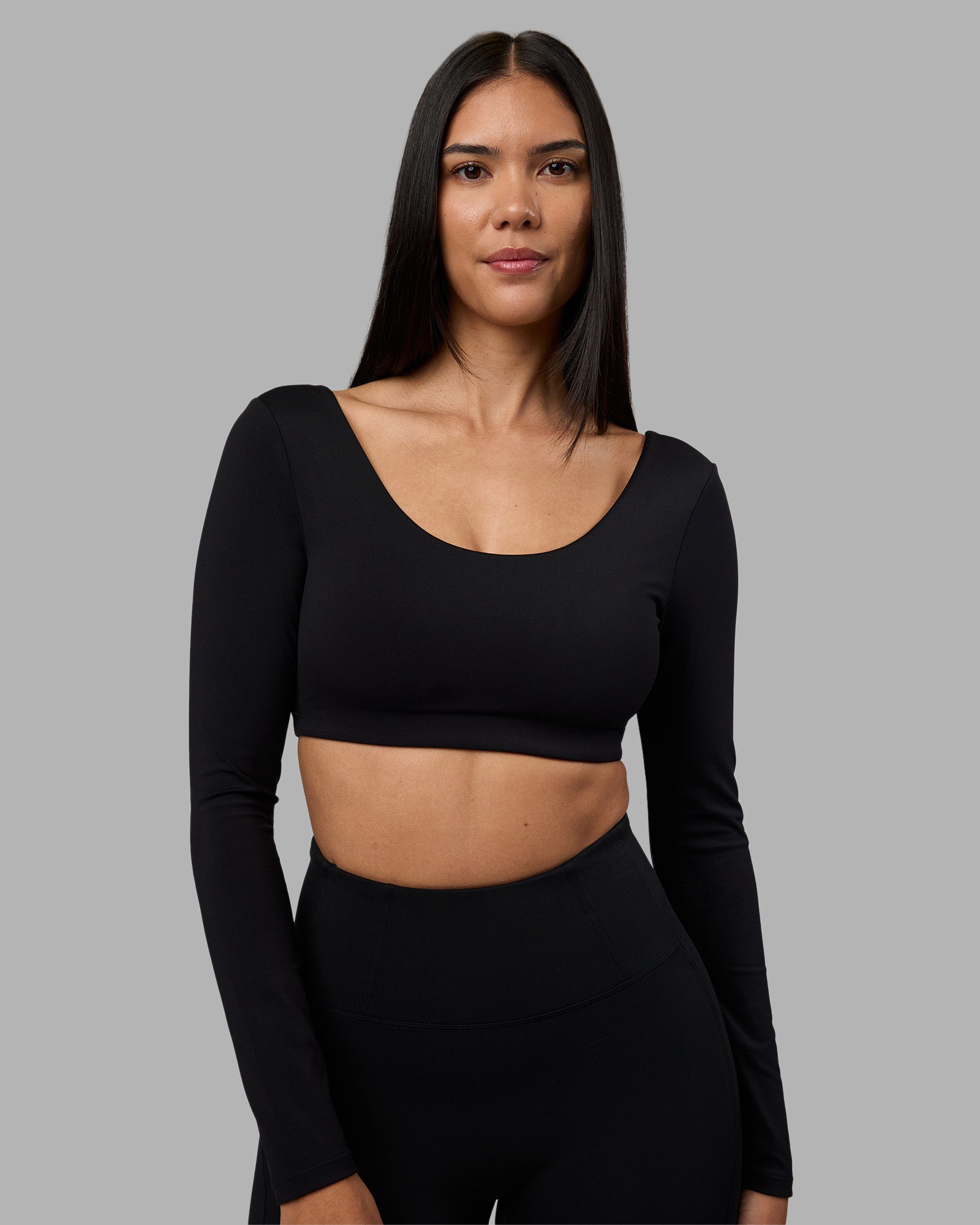 Woman wearing Aria Long Sleeve Sports Bra - Black | Model:Rhiley | Size:S