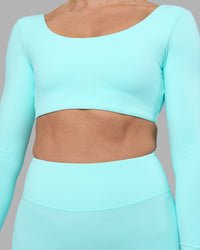 Woman wearing Aria Long Sleeve Sports Bra - Island Paradise | Model:Sophie | Size:S | Thumbnail Index: 5