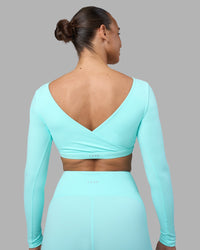 Woman wearing Aria Long Sleeve Sports Bra - Island Paradise | Model:Sophie | Size:S | Thumbnail Index: 1
