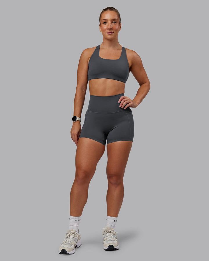 Woman wearing Aspire Sports Bra in Dark Storm | Size:S
