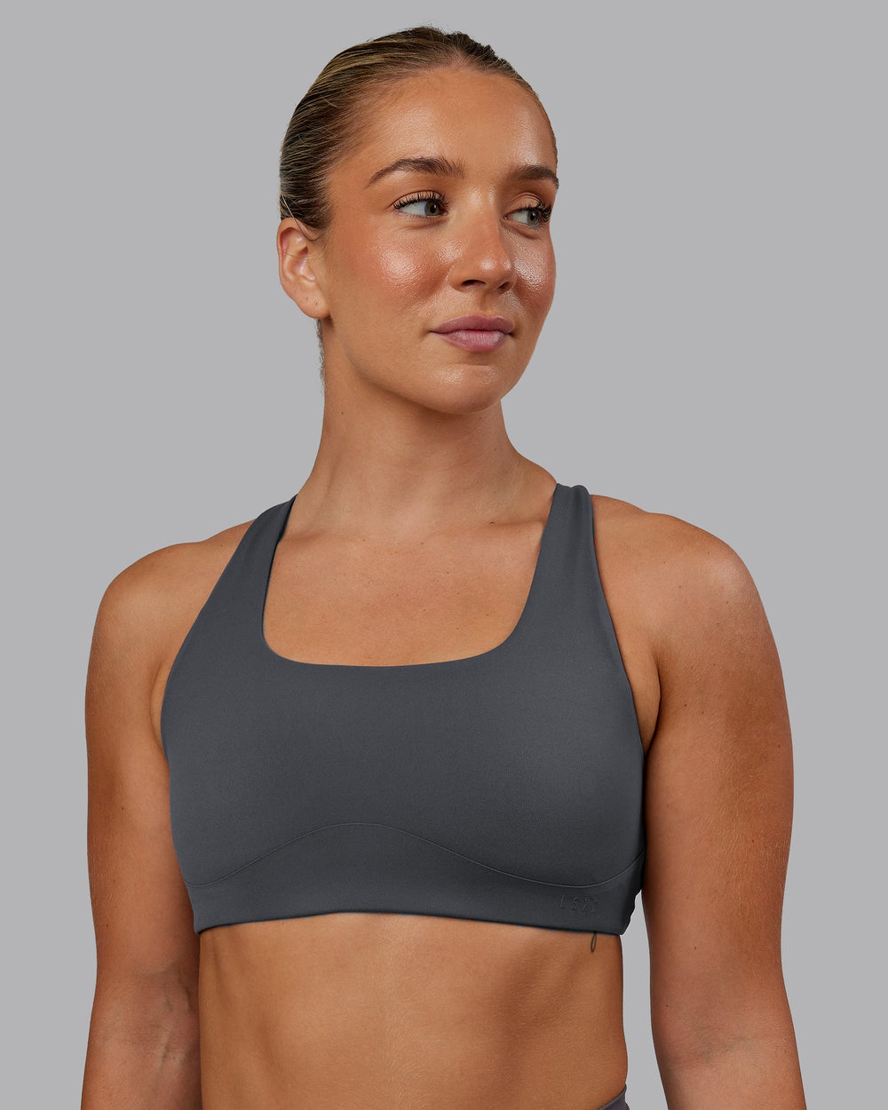 Woman wearing Aspire Sports Bra in Dark Storm | Size:S