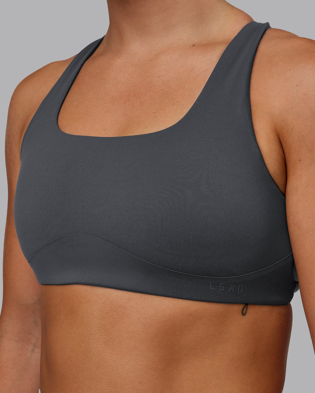 Woman wearing Aspire Sports Bra in Dark Storm | Size:S