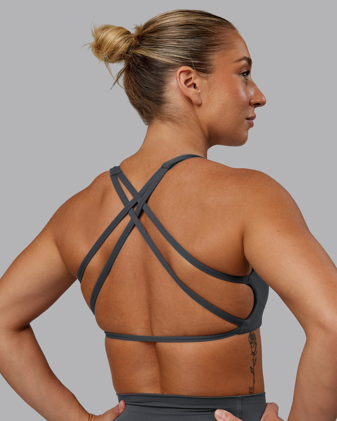 Woman wearing Aspire Sports Bra in Dark Storm | Size:S