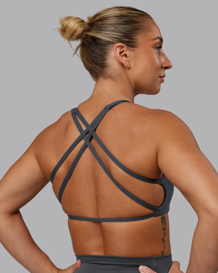 Woman wearing Aspire Sports Bra in Dark Storm | Size:S
