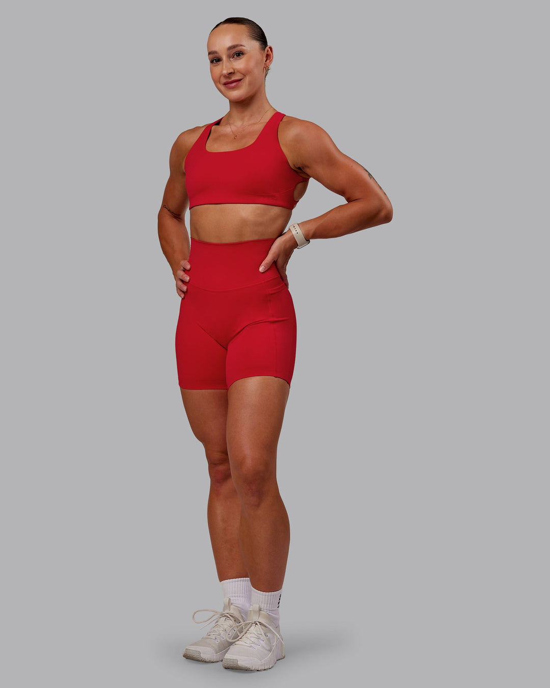 Woman wearing Aspire Sports Bra in Flame | Size:S