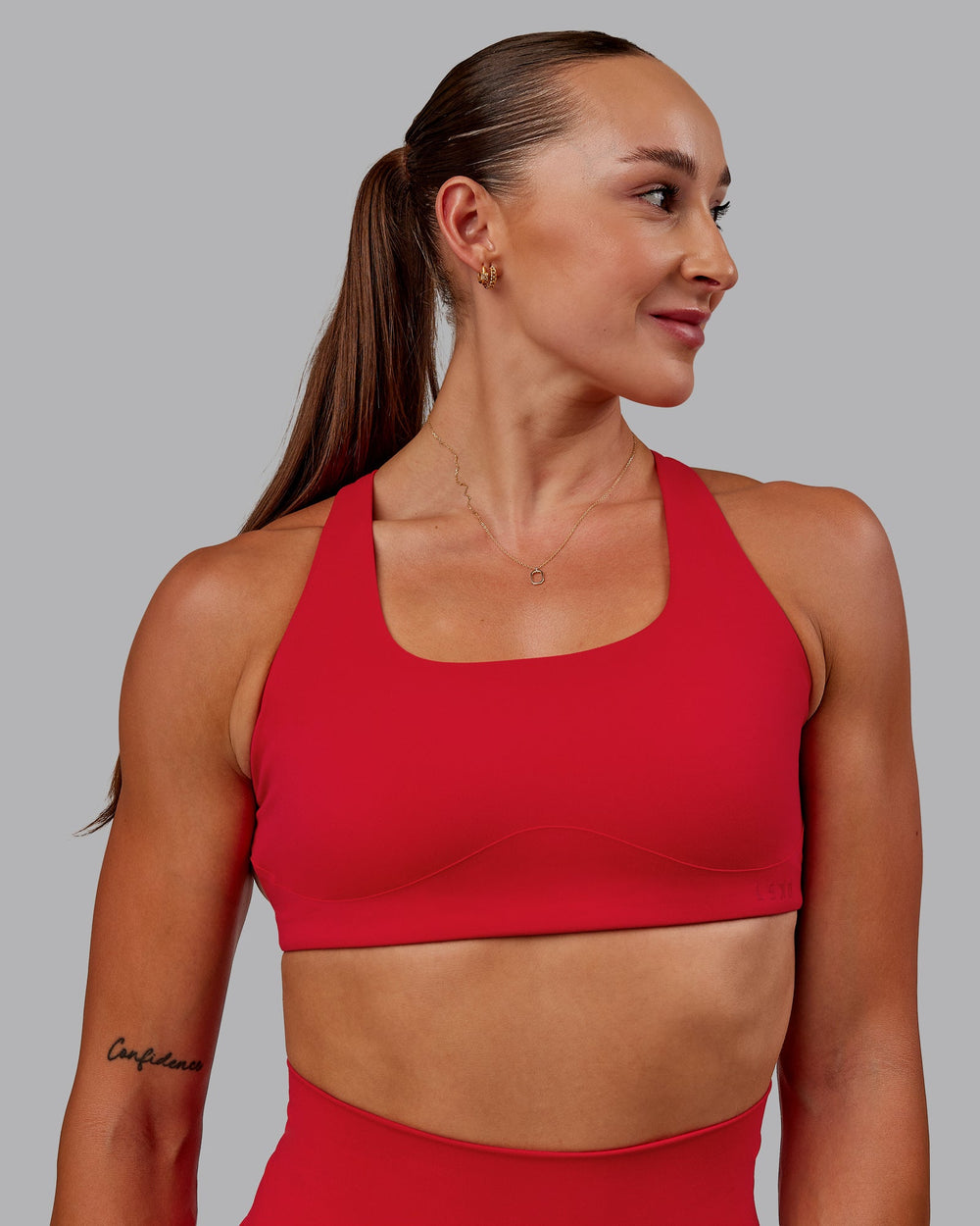 Woman wearing Aspire Sports Bra in Flame | Size:S