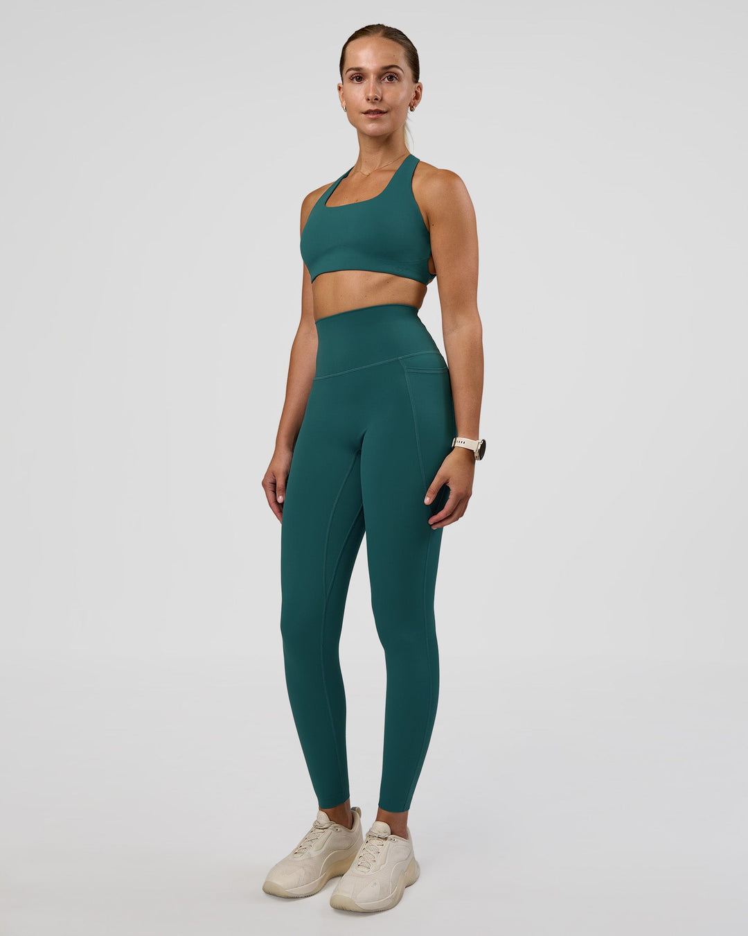Woman wearing Aspire Sports Bra - Transformative Teal | Model:Myrte | Size:S