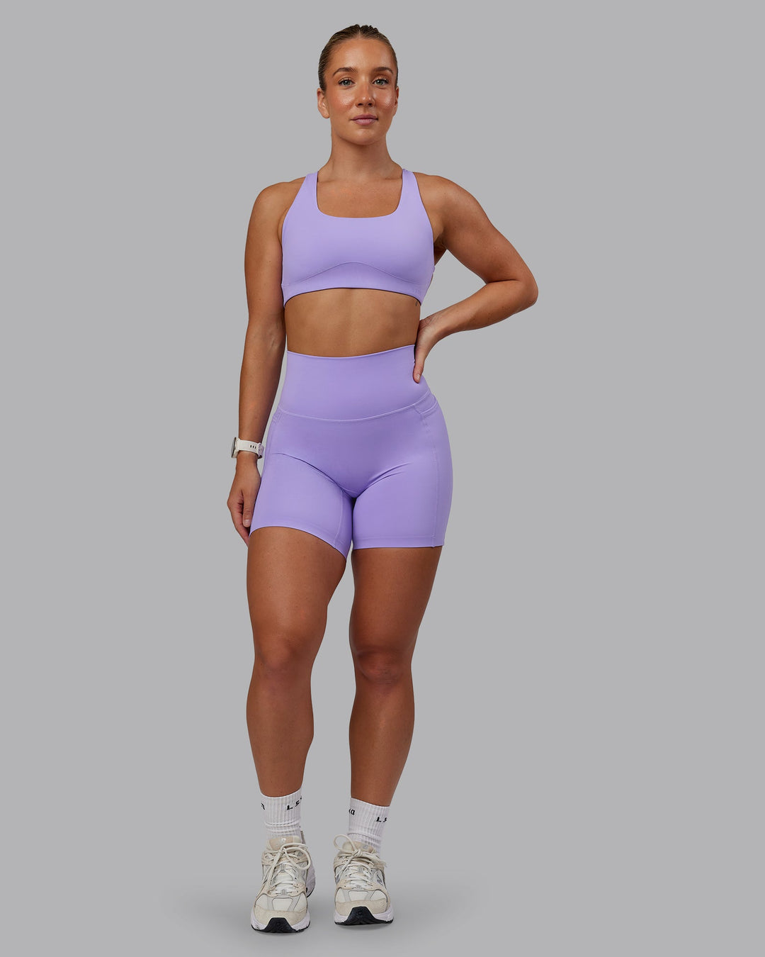 Woman wearing Aspire Sports Bra in Violet Ray | Size:S