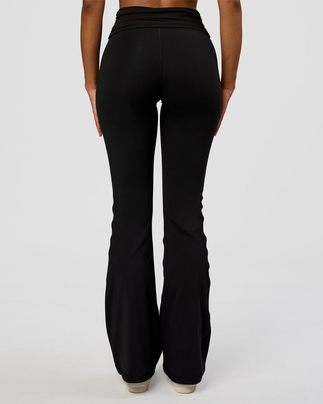 Woman wearing CF Fold Over High-Rise Flared Legging - Black | Model:Jordan | Size:S