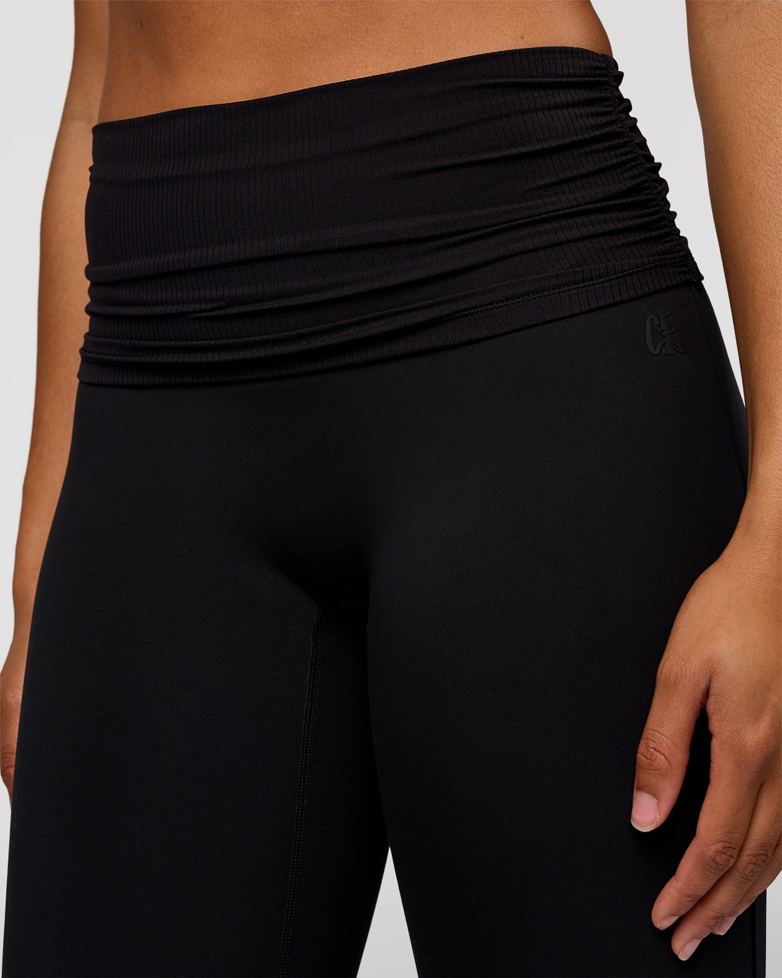 Woman wearing CF Fold Over High-Rise Flared Legging Tall - Black | Model:Rosie | Size:S