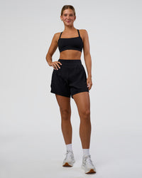 Woman wearing Challenger 5" Lined Performance Short - Black | Model:Amity | Size:S