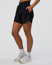 Woman wearing Challenger 5" Lined Performance Short - Black | Model:Amity | Size:S