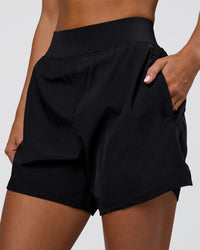 Woman wearing Challenger 5" Lined Performance Short - Black | Model:Amity | Size:S