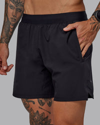 Man wearing Challenger 6" Performance Shorts in Black | Size:S