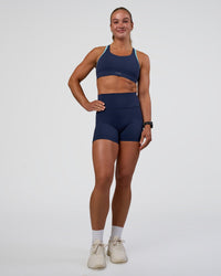 Woman wearing Distinction Sports Bra 2.0 - Future Navy-Baltic Sea | Model:Sav | Size:S
