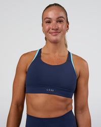 Woman wearing Distinction Sports Bra 2.0 - Future Navy-Baltic Sea | Model:Sav | Size:S