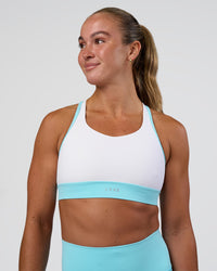 Woman wearing Distinction Sports Bra 2.0 - White-Baltic Sea | Model:Sav | Size:S | Thumbnail Index: 0