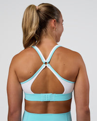 Woman wearing Distinction Sports Bra 2.0 - White-Baltic Sea | Model:Sav | Size:S | Thumbnail Index: 1