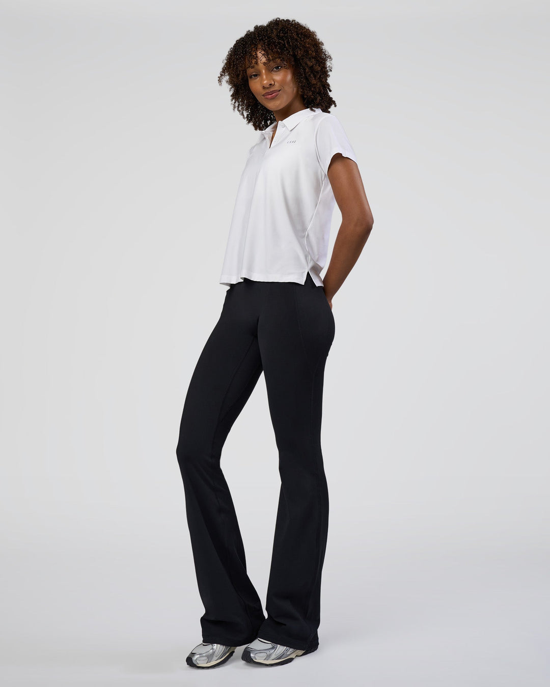 Woman wearing Drive Polo - White | Model:Tomi | Size:S