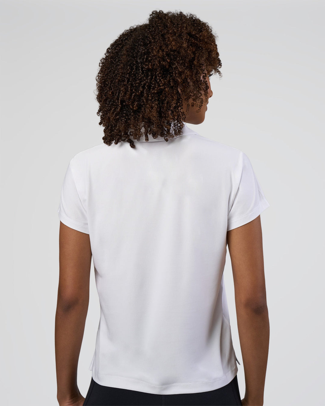 Woman wearing Drive Polo - White | Model:Tomi | Size:S