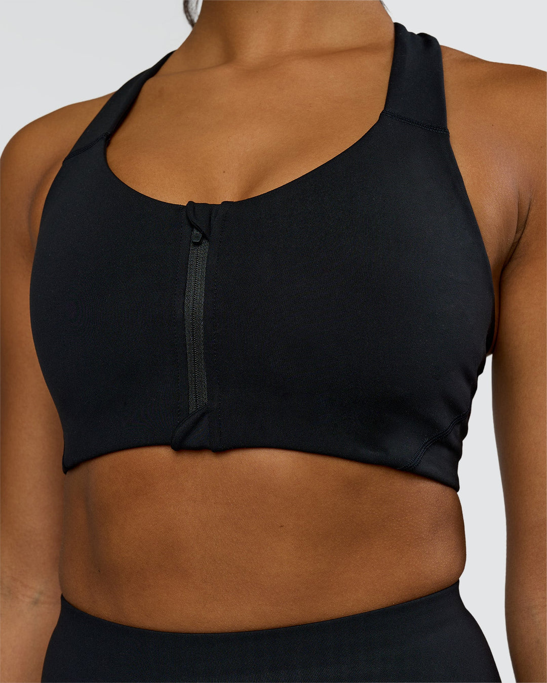 Woman wearing Elarra Zip Front Sports Bra - Black | Model:Rosie | Size:S