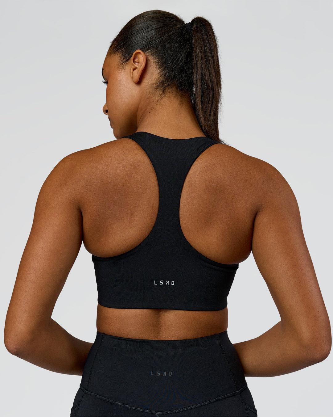 Woman wearing Elarra Zip Front Sports Bra - Black | Model:Rosie | Size:S