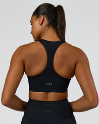 Woman wearing Elarra Zip Front Sports Bra - Black | Model:Rosie | Size:S