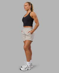 Woman wearing Elevate SoftTouch 4" Short in Shale Beige | Size:S