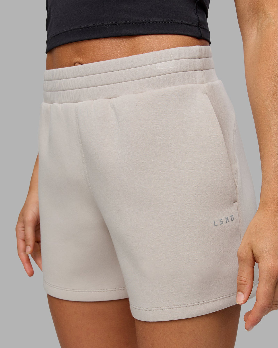 Woman wearing Elevate SoftTouch 4&quot; Short in Shale Beige | Size:S