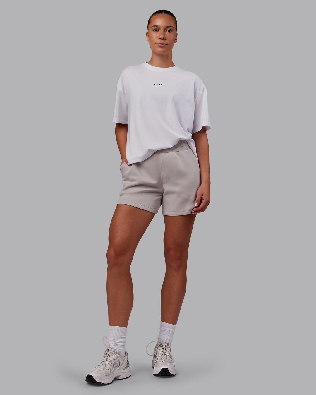 Woman wearing Elevate SoftTouch 4&quot; Short - Warm Grey | Model:Charlize | Size:S