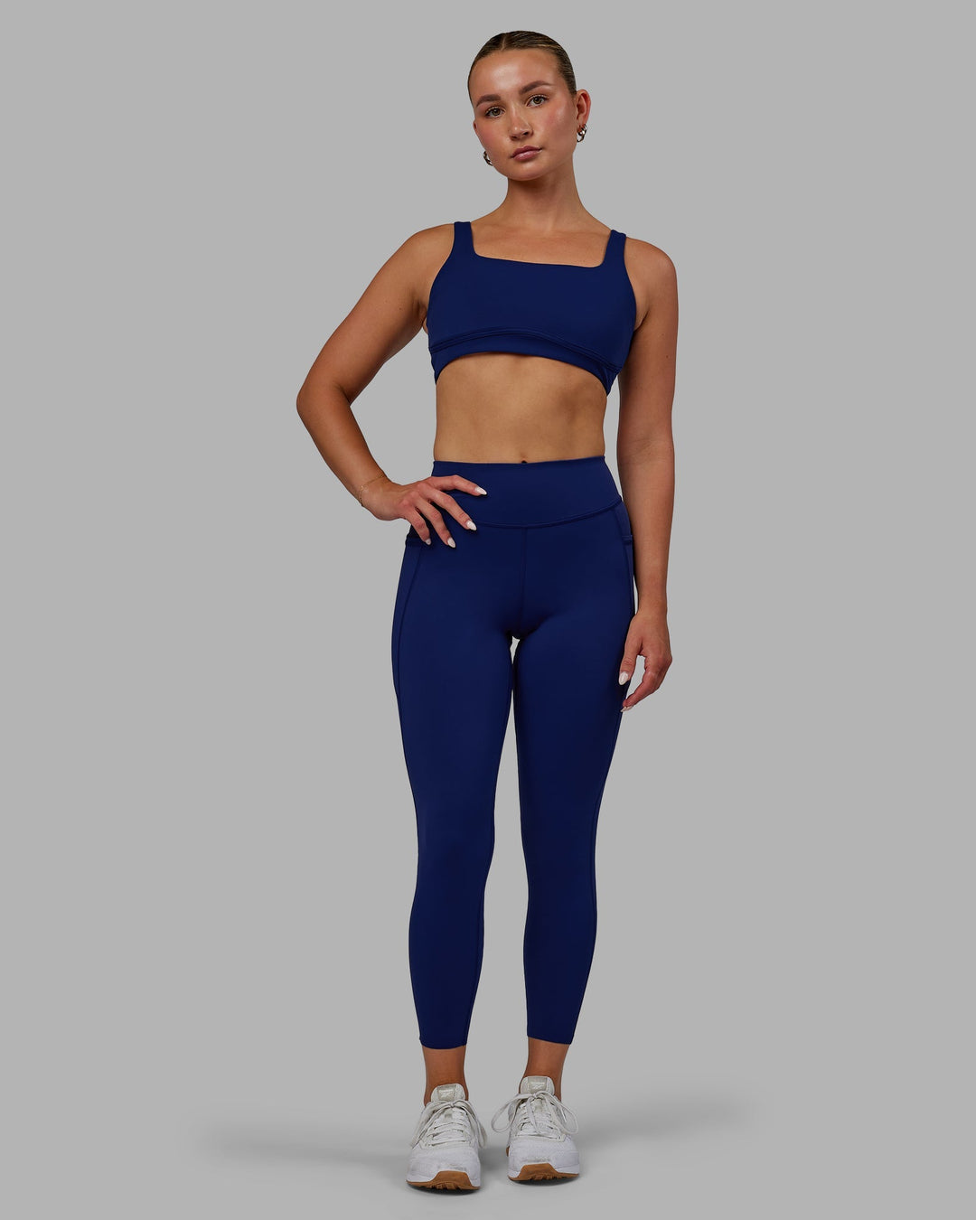 Woman wearing Elite 7/8 Length Leggings - Midnight Blue