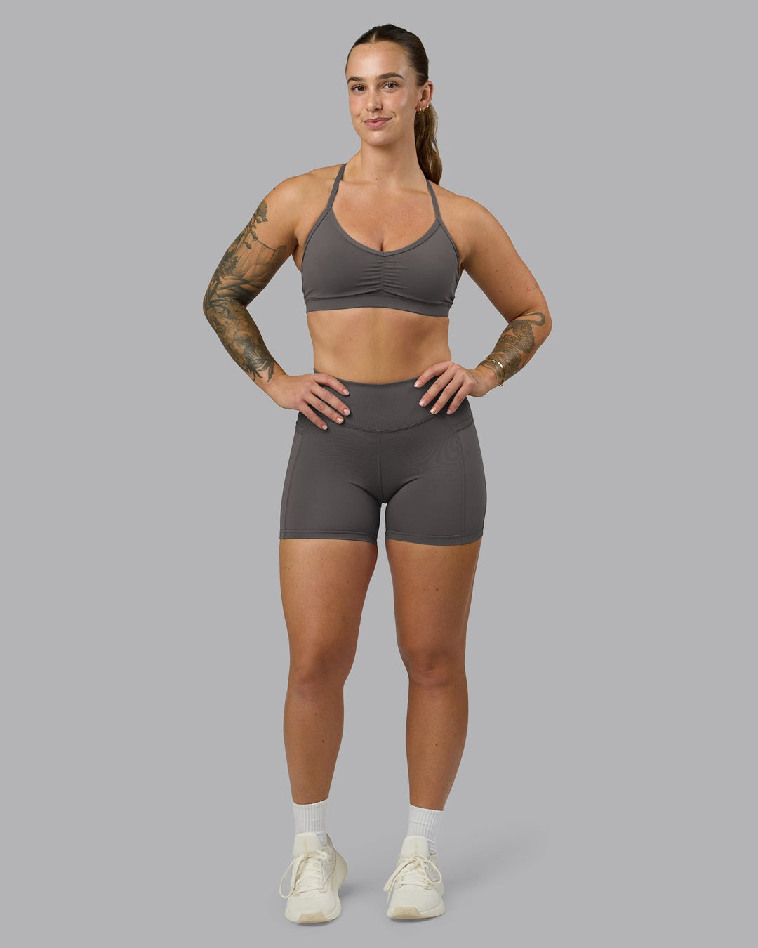 Woman wearing Elite High-Rise 4&quot; Short Pockets - Dark Storm | Model:Robyn | Size:S
