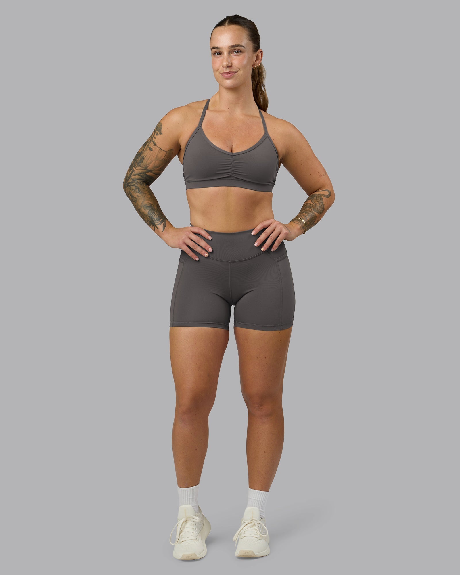 Woman wearing Elite High-Rise 4" Short Pockets - Dark Storm | Model:Robyn | Size:S