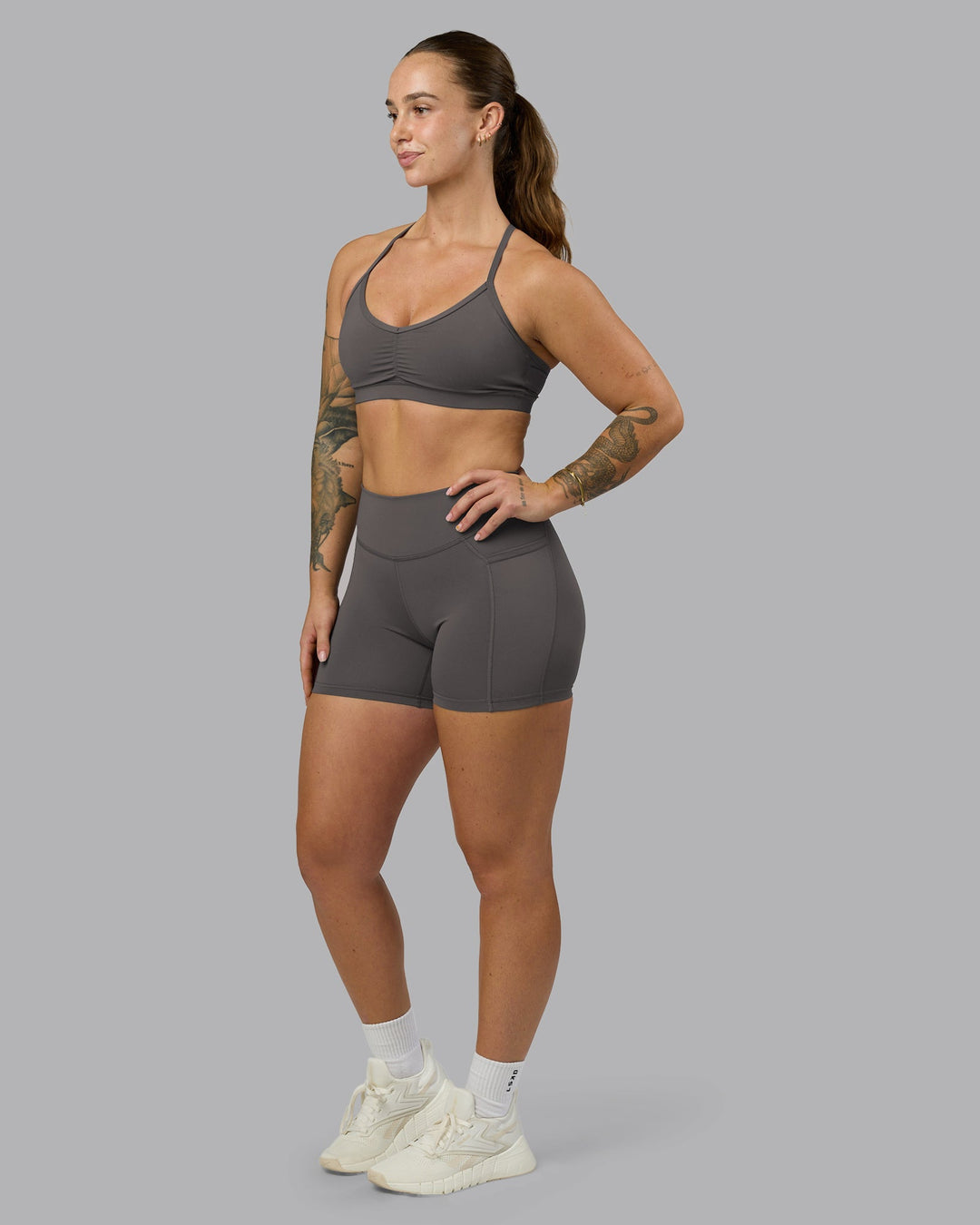 Woman wearing Elite High-Rise 4&quot; Short Pockets - Dark Storm | Model:Robyn | Size:S