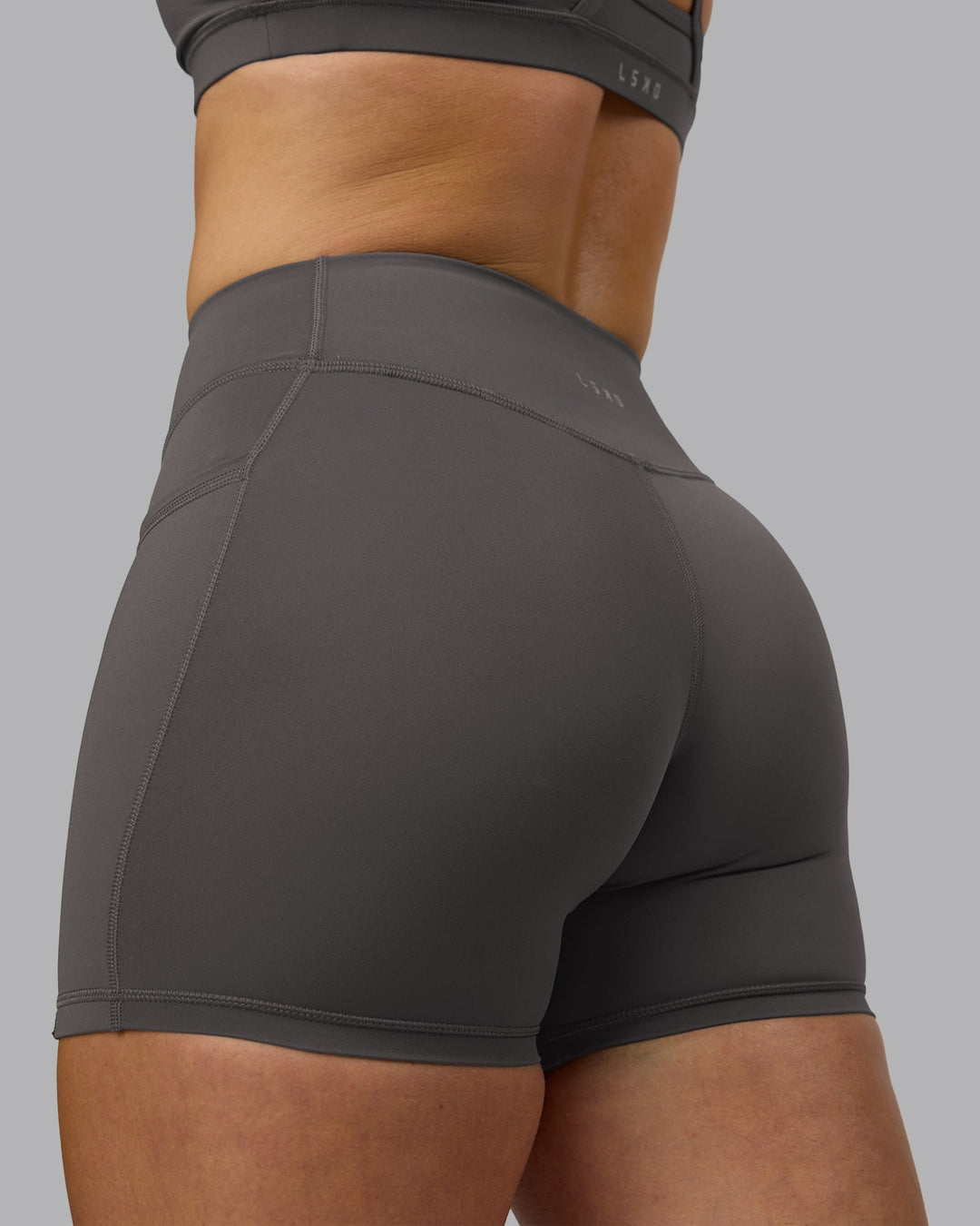 Woman wearing Elite High-Rise 4&quot; Short Pockets - Dark Storm | Model:Robyn | Size:S
