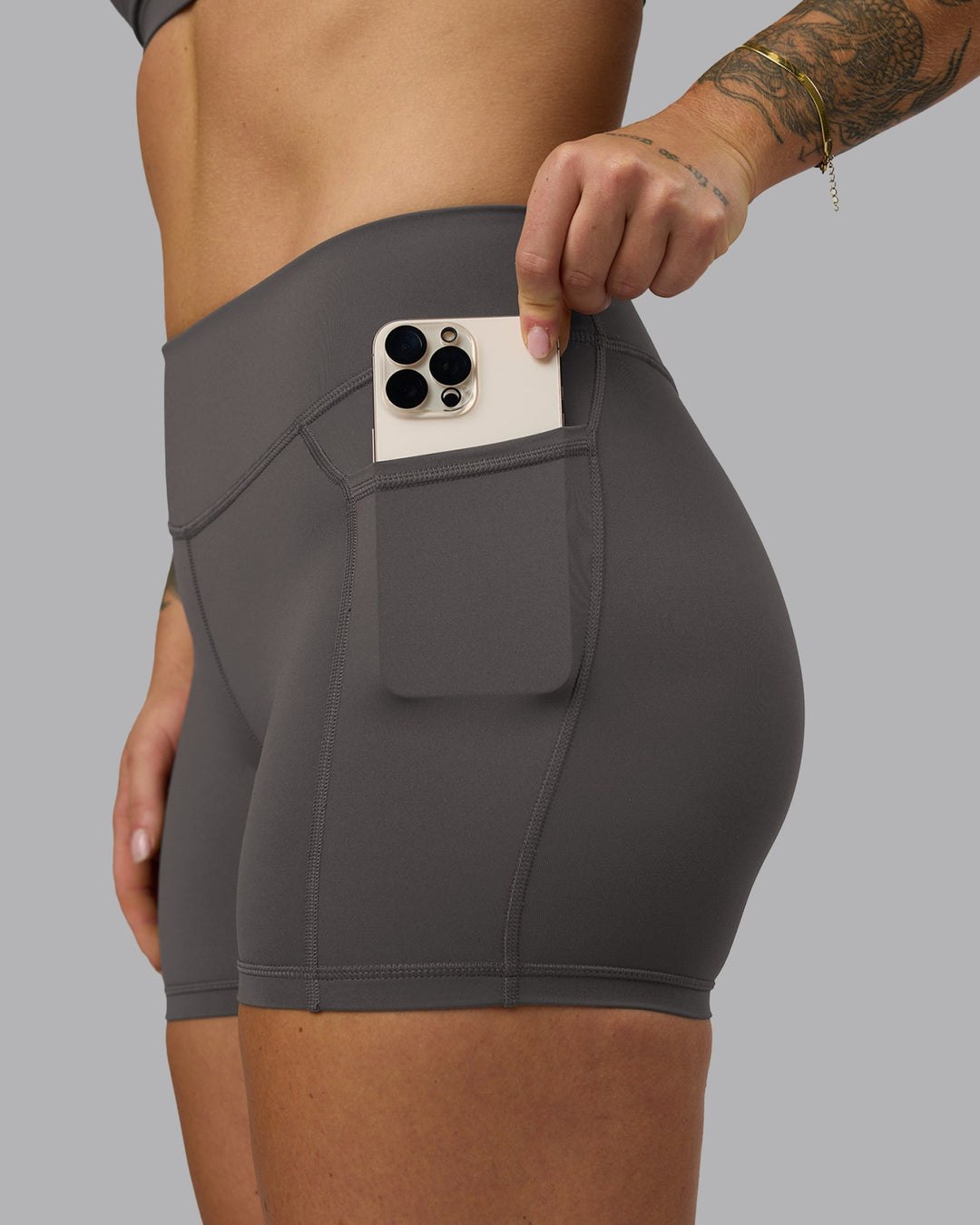 Woman wearing Elite High-Rise 4&quot; Short Pockets - Dark Storm | Model:Robyn | Size:S