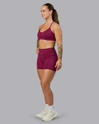 Woman wearing Elite High-Rise 4" Short Pockets - Plum Berry | Model:Robyn | Size:S