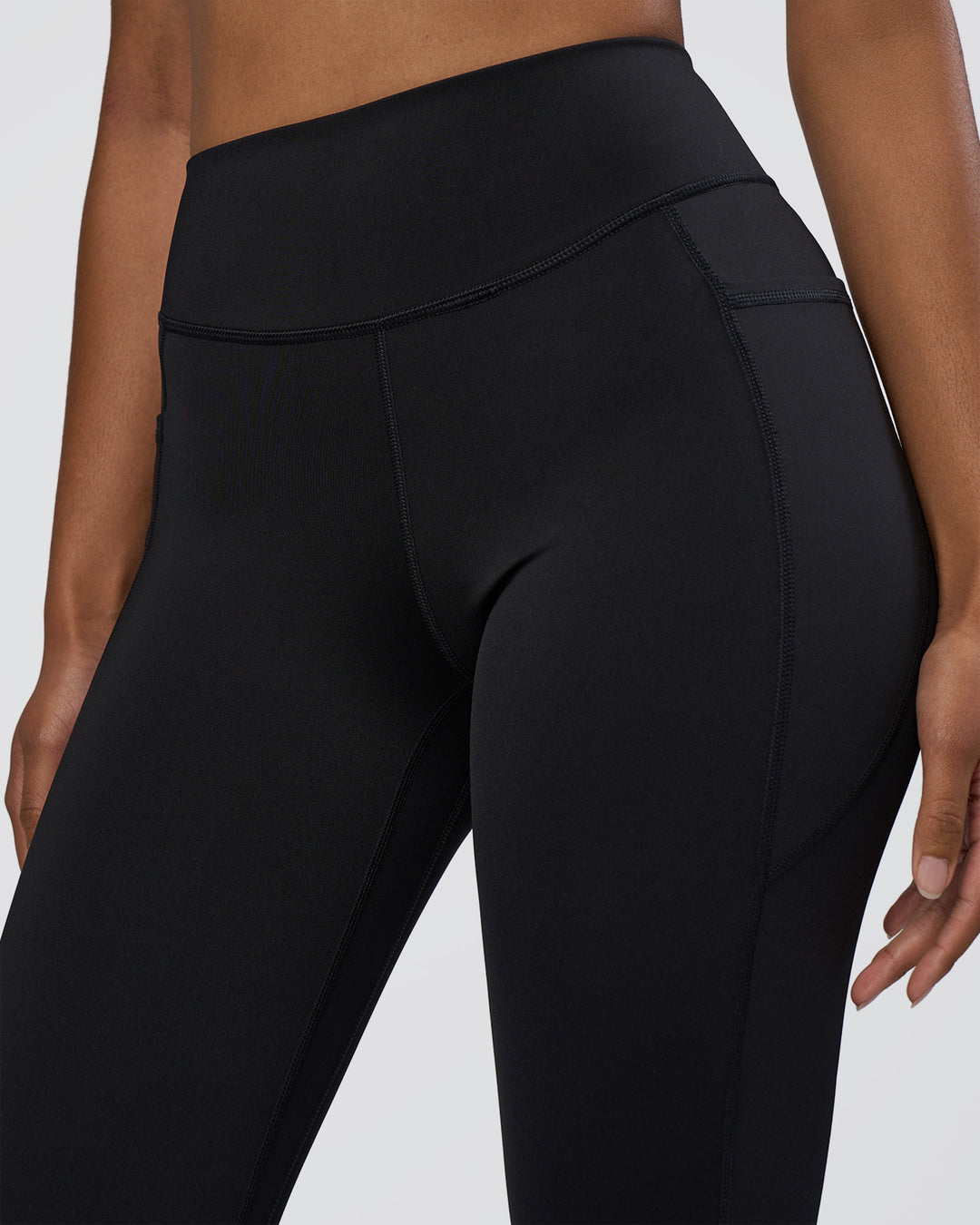 Woman wearing Elite High-Rise 7/8 Legging Pockets - Black | Model:Jordan | Size:S