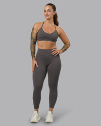 Woman wearing Elite High-Rise 7/8 Legging Pockets - Dark Storm | Model:Robyn | Size:S | Thumbnail Index: 0