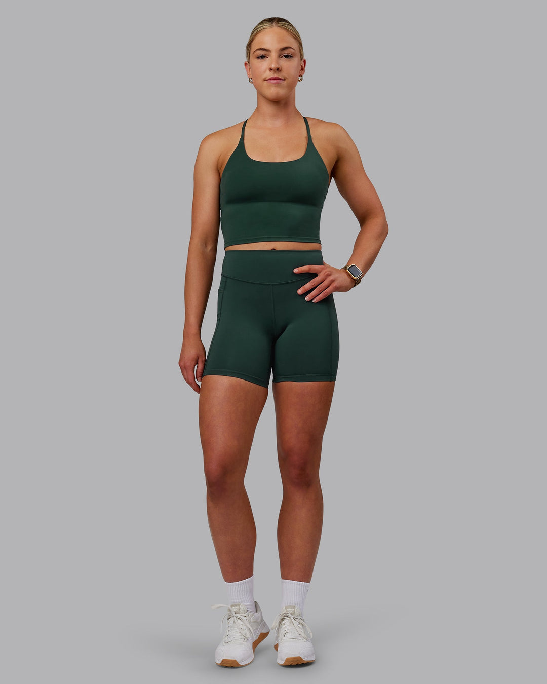 Woman wearing Elite Mid-Length Shorts - Vital Green