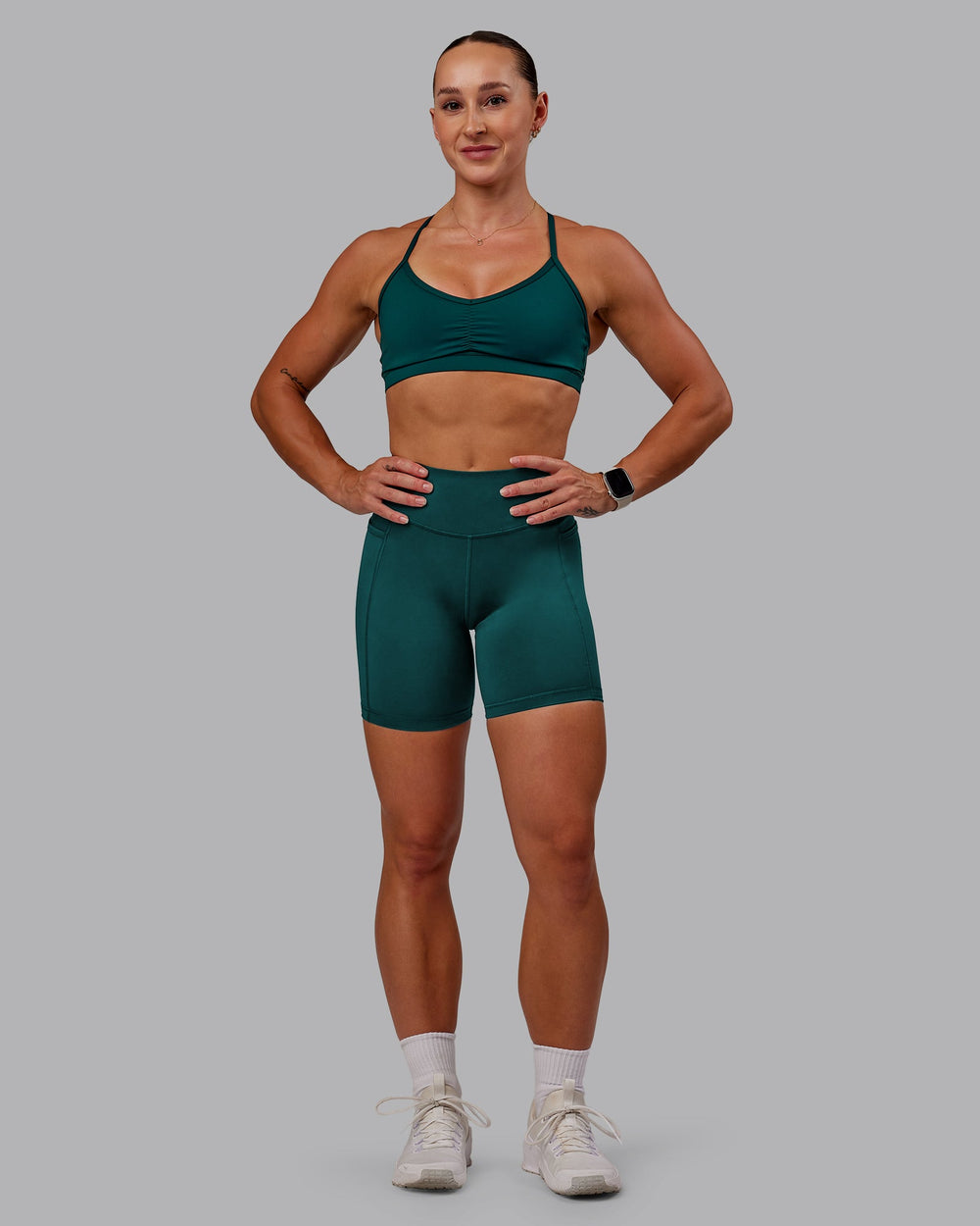 Woman wearing Elite Mid Short Legging in Dark Moss | Size:S