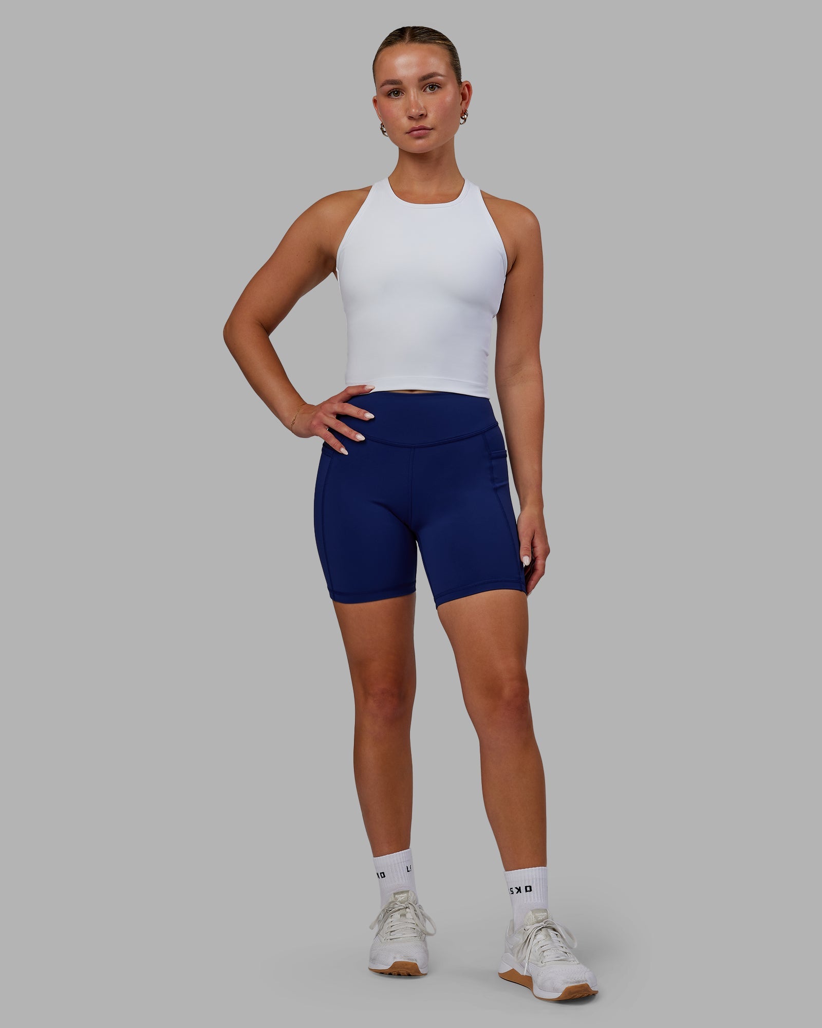Woman wearing Elite High-Rise 6" Short Pockets - Midnight Blue