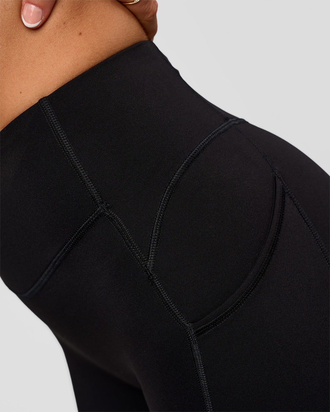 Woman wearing Elite Run High-Rise 5" Short Pockets - Black | Model:Emelia | Size:S